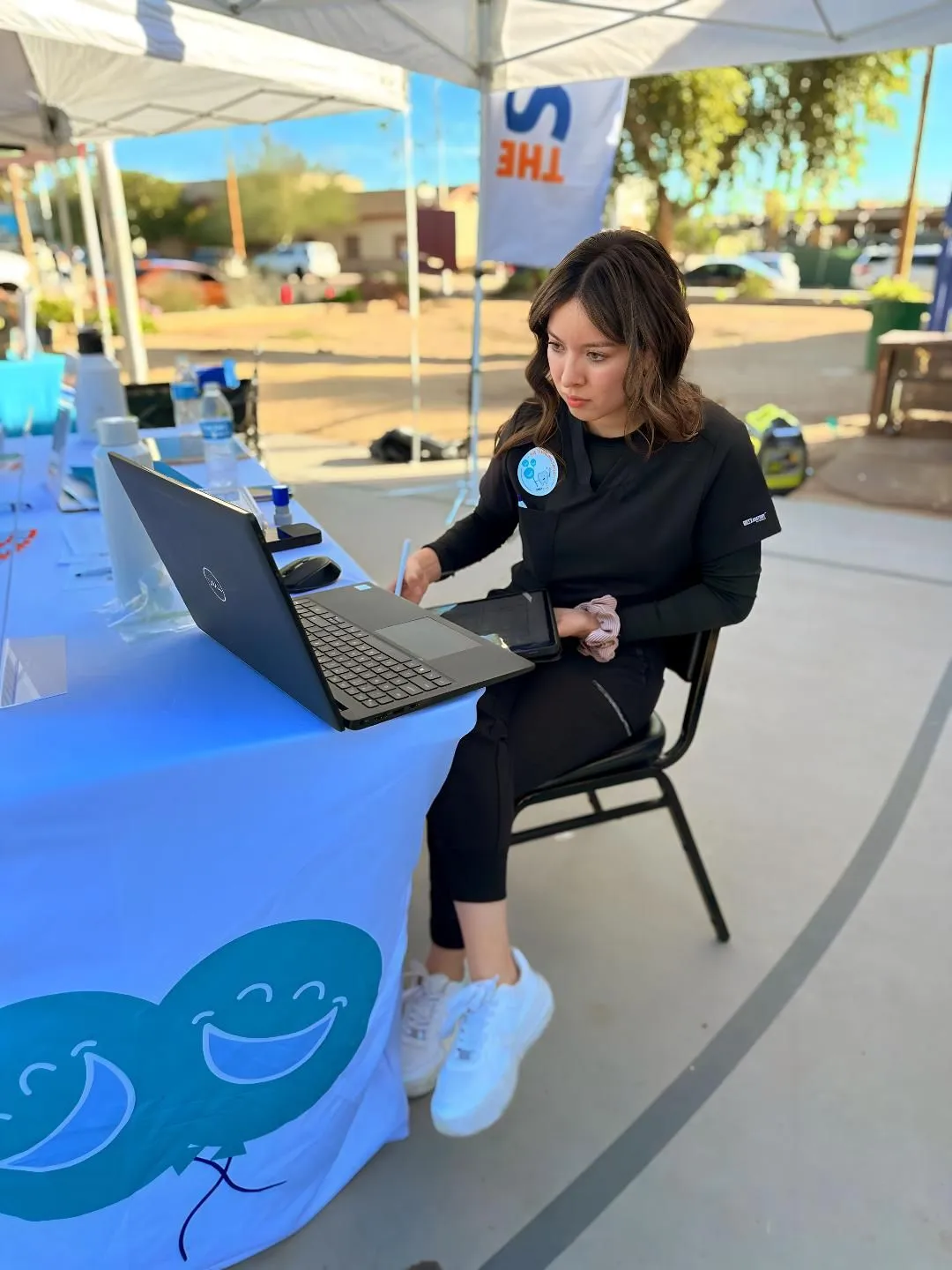 TheSmileZone team member working at a laptop at the Winter Festival