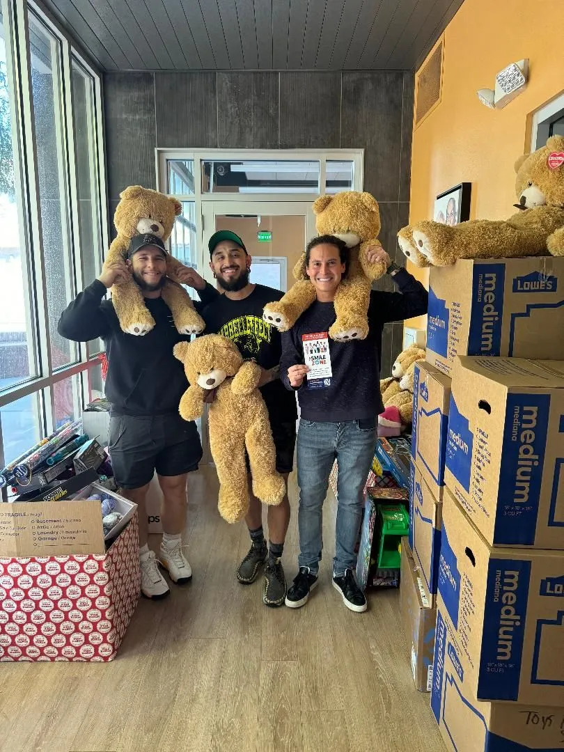 Volunteer holding teddy bears donated to the holiday toy drive