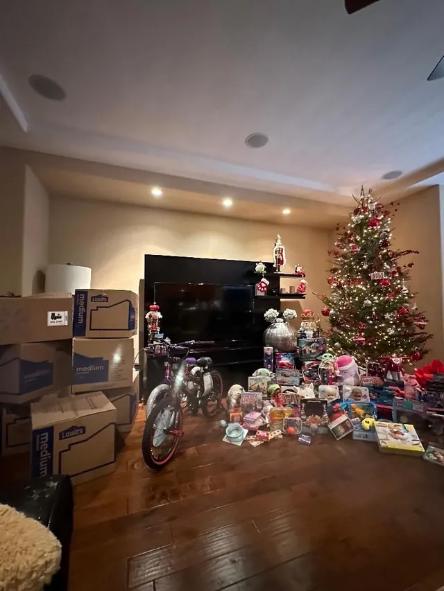Donated toys gathered beside a Christmas tree