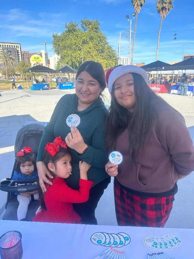 Family holding dental kits at the Winter Festival