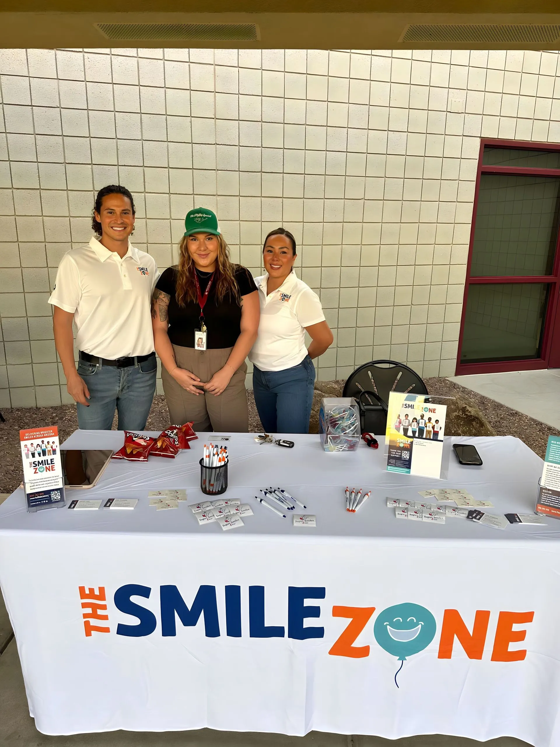 TheSmileZone team at an outreach table