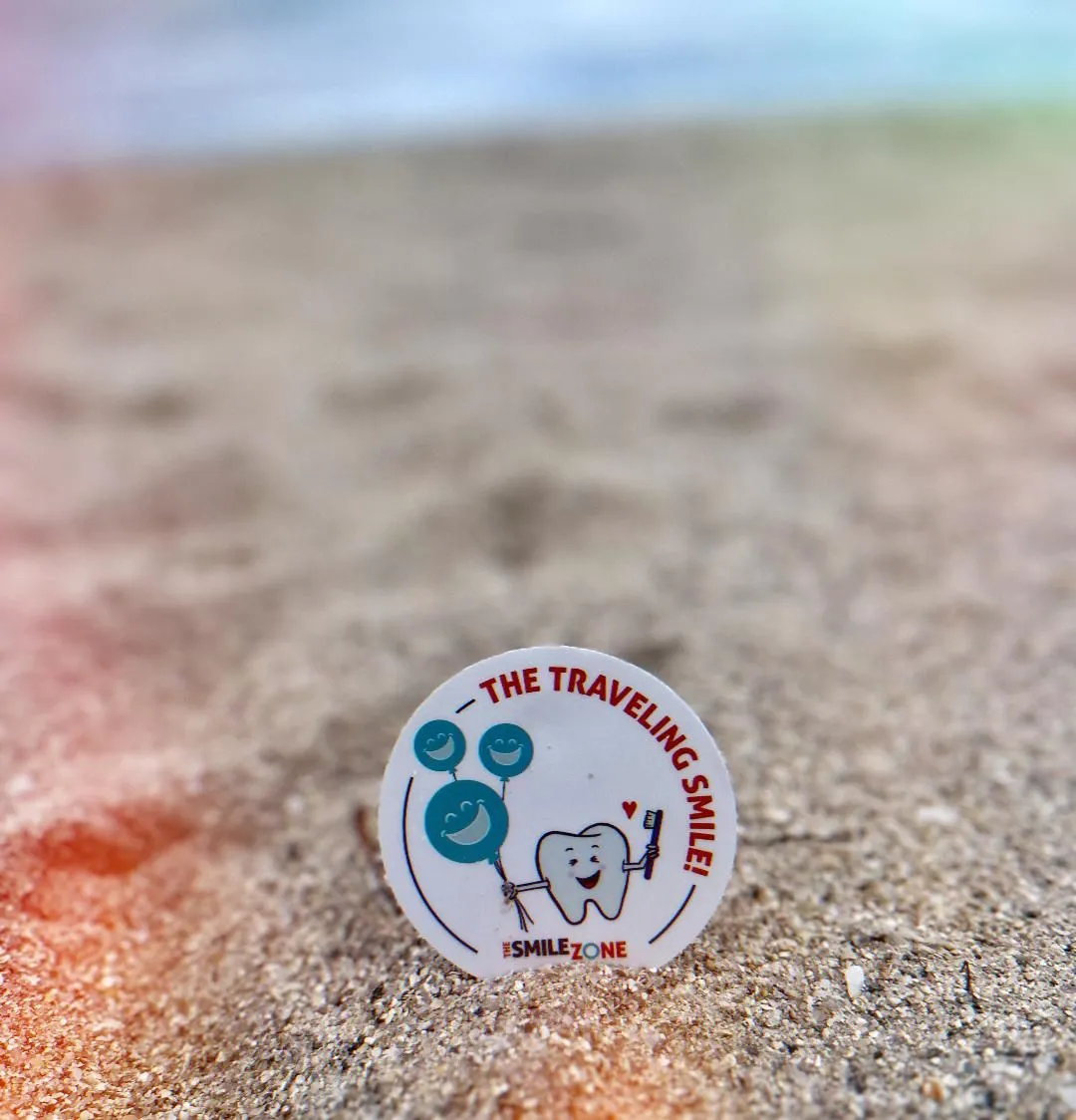 TheSmileZone traveling smile badge on a beach in Miami